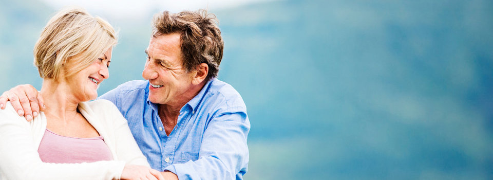 woman on a wheelchair smiling at her husband