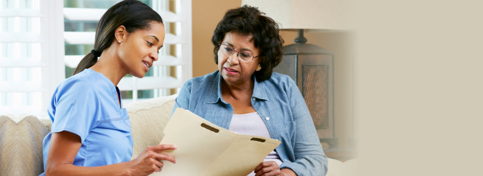 healthcare agent visiting elderly woman at home
