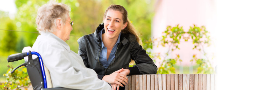 elderly woman talking to a woman