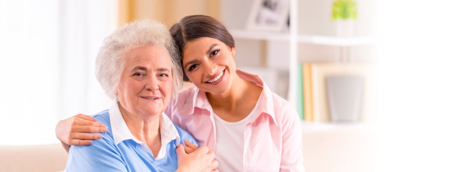 elderly woman and a young woman smiling